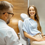 Female patient smiling at dentist at dental appointment