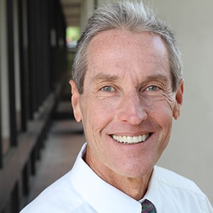 Man smiling in a hallway